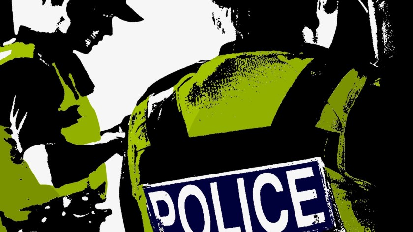 A picture showing two police officers in hi-vis jackets.